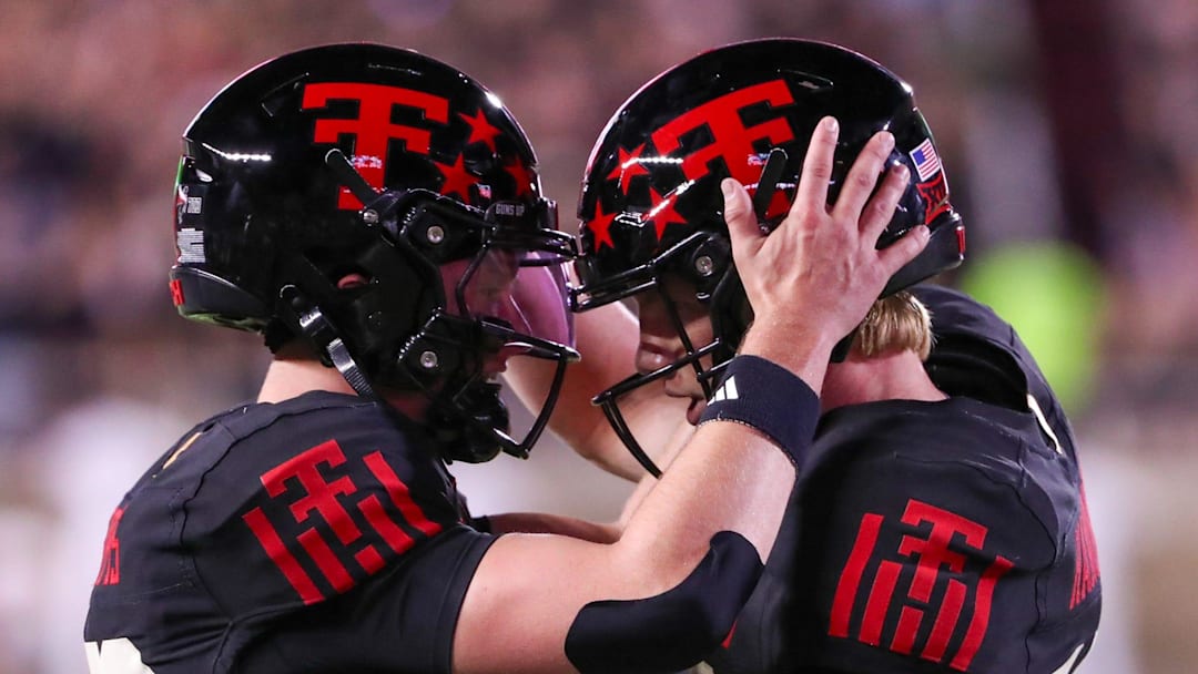 Texas Tech's Will Hammond (right) celebrates a touchdown with Mitch Griffis against Kansas during a Big 12 Conference football game, Saturday, Oct. 11, 2025, at Jones AT&T Stadium in Lubbock.