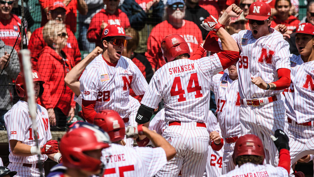 Gabe Swansen (44) celebrates his grand slam with the Husker dugout. 