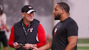 Texas Tech general manager James Blanchard speaks with head coach Joey McGuire during spring practice
