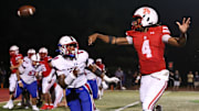 Archbishop Spalding quarterback Malik Washington follows through on a short touchdown toss, as DeMatha's Carey Darrell applies pressure. Spalding won the showdown between the Nos. 3 and 4 teams in last week's Maryland Top 25, 26-10.