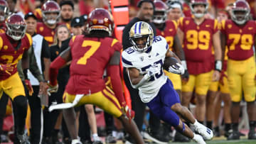 Nov 4, 2023; Los Angeles, California, USA; Washington Huskies running back Tybo Rogers (20) carries the ball against USC Trojans safety Calen Bullock (7) during the second quarter at United Airlines Field at Los Angeles Memorial Coliseum. Mandatory Credit: Jonathan Hui-USA TODAY Sports