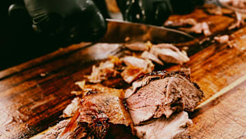 Pitmaster Al Frugoni cuts open a grilled lamb during the second day of the SmokeSlam Barbecue Festival on Friday, May 16, 2025 at Tom Lee Park in Memphis, Tenn.