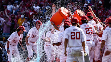 The Huskers splash Case Sanderson as he gets to home plate. 