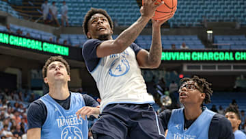 North Carolina guard Jaydon Young going up for a layup with Luka Bogavac and James Brown in the background at the Blue-White scrimmage.