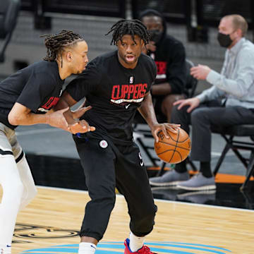 Mar 25, 2021; San Antonio, Texas, USA; Los Angeles Clippers guard Amir Coffey (7) and center Daniel Oturu (10) warm up before the game against the San Antonio Spurs at the AT&T Center. Mandatory Credit: Daniel Dunn-Imagn Images