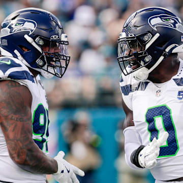Oct 12, 2025; Jacksonville, Florida, USA;Seattle Seahawks defensive end Leonard Williams (99) and linebacker DeMarcus Lawrence (0) celebrate after a play against the Jacksonville Jaguars at EverBank Stadium. Mandatory Credit: Travis Register-Imagn Images