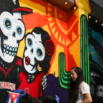 Fans color in pictures of Baxter and the Arizona Diamondbacks logo on Aug. 30, 2024, at Chase Field in Phoenix.