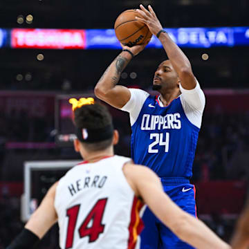 Jan 1, 2024; Los Angeles, California, USA; Los Angeles Clippers guard Norman Powell (24) shoots against Miami Heat guard Tyler Herro (14) during the second quarter at Crypto.com Arena. Mandatory Credit: Jonathan Hui-Imagn Images