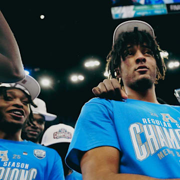 PJ Haggerty holds the AAC regular season champion trophy 