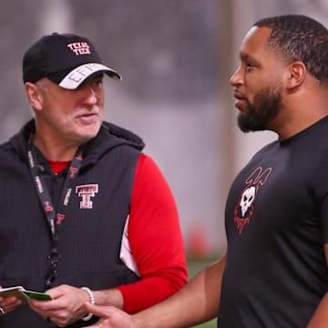 Texas Tech general manager James Blanchard speaks with head coach Joey McGuire 
