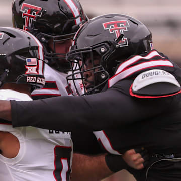 Lee Hunter wraps up Quinten Joyner for a tackle during the Texas Tech football team's spring game.