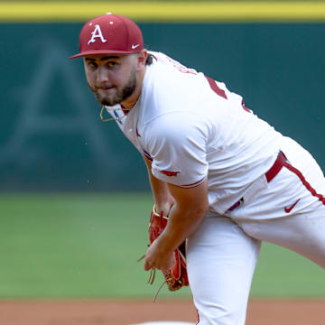 Arkansas Razorbacks pitcher Zach Root throws against the Tennessee Volunteers  in an NCAA Super Regional in Fayetteville, Ark.