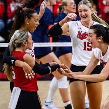 Virginia Adriano, right, high fives Laney Choboy after a kill. The Huskers face their toughest stretch of the season with four of their next five matches on the road.
