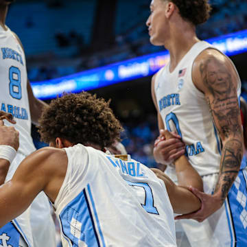 North Carolina Seth Trimble getting helped up by teammates Caleb Wilson (8) and Kyan Evans (0) during North Carolina's exhibition game against Winston-Salem State on Oct. 29, 2025.