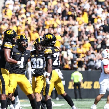 Iowa's Jermari Harris (right) celebrates his interception with teammates. (Photo: Rob Howe/HN) 