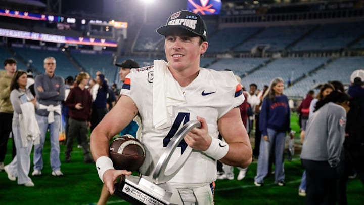 Dec 27, 2025; Jacksonville, FL, USA; Virginia Cavaliers quarterback Chandler Morris (4) poses with the MVP trophy after defeating the Missouri Tigers at EverBank Stadium. Mandatory Credit: Travis Register-Imagn Images