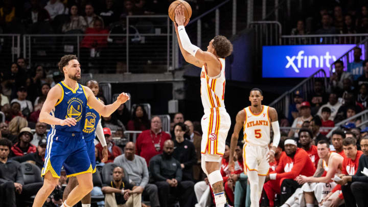 Feb 3, 2024; Atlanta, Georgia, USA; Atlanta Hawks guard Trae Young (11) shoots three point shot against Golden State Warriors guard Cory Joseph (1) during the third quarter at State Farm Arena. Mandatory Credit: Jordan Godfree-USA TODAY Sports