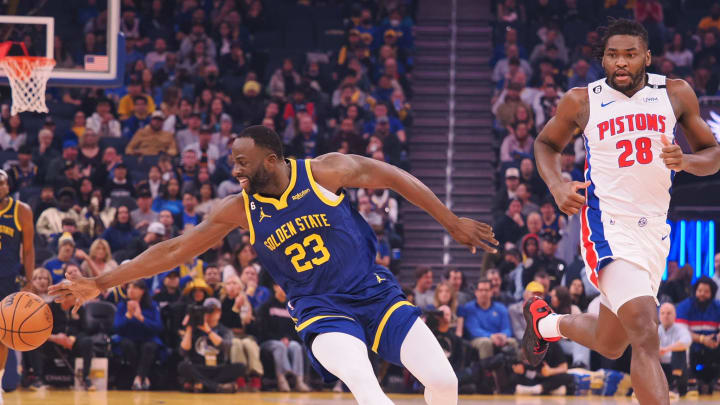 Jan 4, 2023; San Francisco, California, USA; Golden State Warriors forward Draymond Green (23) extends for the ball against Detroit Pistons center Isaiah Stewart (28) at Chase Center. Mandatory Credit: Kelley L Cox-USA TODAY Sports