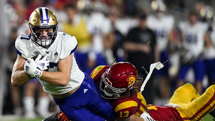 Nov 4, 2023; Los Angeles, California, USA; USC Trojans linebacker Mason Cobb (13) tackles Washington Huskies tight end Jack Westover (37) during the third quarter at United Airlines Field at Los Angeles Memorial Coliseum. Mandatory Credit: Jonathan Hui-Imagn Images