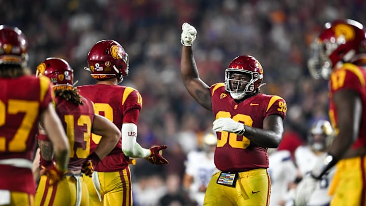 Nov 4, 2023; Los Angeles, California, USA; USC Trojans defensive lineman Bear Alexander (90) celebrates with linebacker Eric Gentry (18) and other teammates against the Washington Huskies during the fourth quarter at United Airlines Field at Los Angeles Memorial Coliseum. Mandatory Credit: Jonathan Hui-Imagn Images Nov 4, 2023; Los Angeles, California, USA; USC Trojans defensive lineman Bear Alexander (90) celebrates with linebacker Eric Gentry (18) and other teammates against the Washington Huskies during the fourth quarter at United Airlines Field at Los Angeles Memorial Coliseum. Mandatory Credit: Jonathan Hui-Imagn Images