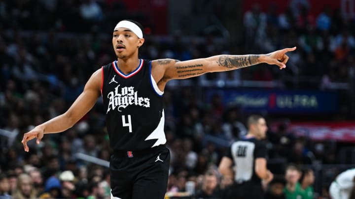 Dec 23, 2023; Los Angeles, California, USA; Los Angeles Clippers guard Brandon Boston Jr. (4) points against the Boston Celtics during the fourth quarter at Crypto.com Arena. Mandatory Credit: Jonathan Hui-USA TODAY Sports