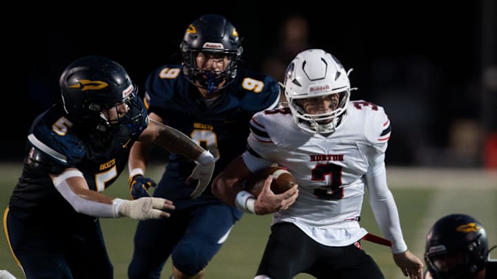 Norton’s Trey Kersten with a carry, Streetsboro’s Ayden Knuebell and Kyle Giacomo on defense on Sept. 26, 2025. Norton’s Trey Kersten with a carry, Streetsboro’s Ayden Knuebell and Kyle Giacomo on defense on Sept. 26, 2025.