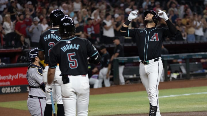 Arizona Diamondbacks third baseman Eugenio Suarez (28) crosses home plate after hitting a two-run home run on July 10, 2024 at Chase Field in Phoenix.