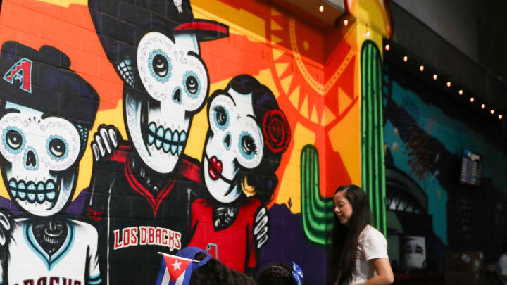 Fans color in pictures of Baxter and the Arizona Diamondbacks logo on Aug. 30, 2024, at Chase Field in Phoenix.