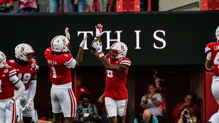 Nebraska Cornhuskers defensive back Tommi Hill (6) celebrates his pick six with teammate Jimari Butler (1).