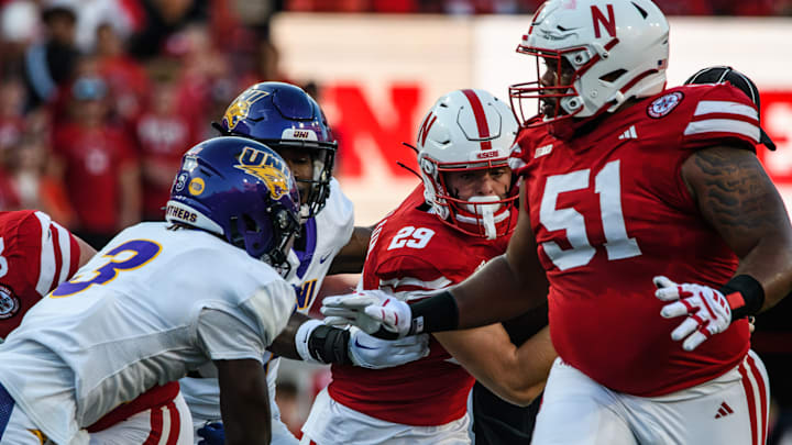 Carter Nelson (29) runs with the ball past UNI defenders.  