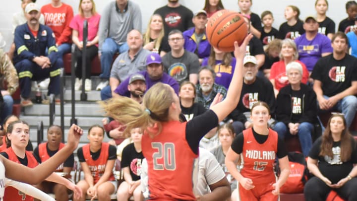 Midland's Camri Primeaux (20) goes up for two points. Midland's Camri Primeaux (20) goes up for two points.