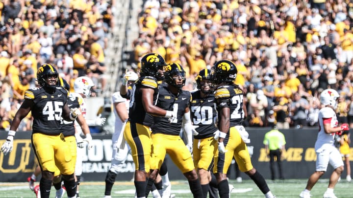 Iowa's Jermari Harris (right) celebrates his interception with teammates. (Photo: Rob Howe/HN) 