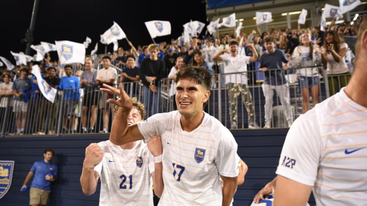 Pitt Men's Soccer forward Luis Sahmkow celebrates with the fans after scoring a goal in the 2-0 win over No. 16 Georgetown at Ambrose Urbanic Field 