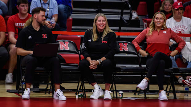 Coach Busboom Kelly smiles after a rally on the court. 