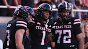 Texas Tech's Reggie Virgil celebrates his third touchdown against UCF with teammates Coy Eakin (3) and Sheridan Wilson during a Big 12 Conference football game