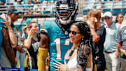 Jacksonville Jaguars player Travis Hunter (12) with his wife during pregame against the Houston Texans at EverBank Stadium.