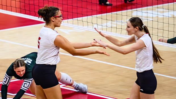 Rebekah Allick (left) and Bergen Reilly (right) celebrate a block. 