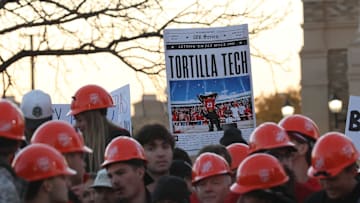 Texas Tech Red Raider fans hold signs while waiting for the start of ESPN's College GameDay