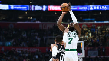 Dec 23, 2023; Los Angeles, California, USA; Boston Celtics forward Jaylen Brown (7) shoots against Los Angeles Clippers guard Russell Westbrook (0) during the second quarter at Crypto.com Arena. Mandatory Credit: Jonathan Hui-USA TODAY Sports