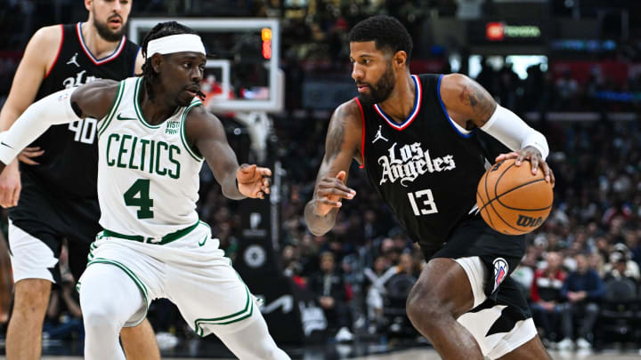 Dec 23, 2023; Los Angeles, California, USA; Los Angeles Clippers forward Paul George (13) moves the ball against Boston Celtics guard Jrue Holiday (4) during the third quarter at Crypto.com Arena. Mandatory Credit: Jonathan Hui-USA TODAY Sports