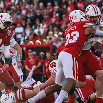 Javin Wright (33) makes a tackle on a Wisconsin runner. 