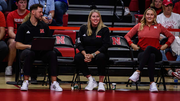 Coach Busboom Kelly smiles after a rally on the court. 
