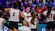 The Huskers run towards Andi Jackson after her kill in the spring match against Kansas.