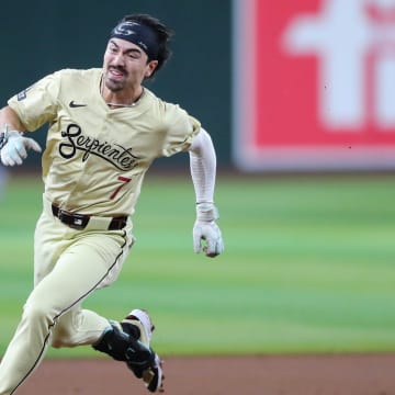 Arizona Diamondbacks outfielder Corbin Carroll's (7) helmet falls off while he runs the bases for an inside-the-park home run at Chase Field on Aug. 31, 2024, in Phoenix.