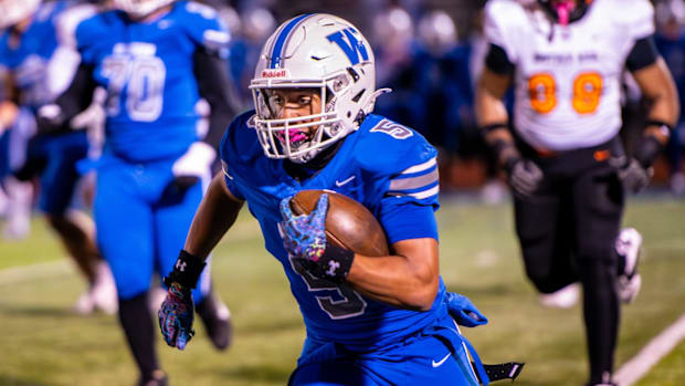 Walled Lake Western's Donovan Triplett rushes during a Division 2 football game on Friday, Oct. 31, 2025, at Dick Watson Fiel