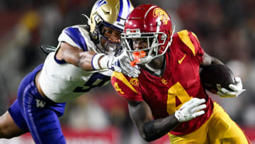 Nov 4, 2023; Los Angeles, California, USA; Washington Huskies cornerback Thaddeus Dixon (9) tackles USC Trojans wide receiver Mario Williams (4) during the fourth quarter at United Airlines Field at Los Angeles Memorial Coliseum. Mandatory Credit: 