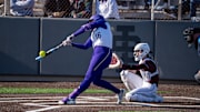 Alexis DeBoer, the ex-Husky football coach's daughter, shows perfect extension on this UW home run.