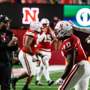 Willis McGahee IV (17) and Princewill Umanmielen celebrate Nebraska’s recovery of a Colorado fumble to secure the win. 