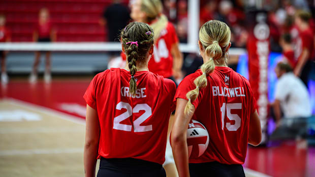 Lindsay Krause (22) and Leyla Blackwell (15) watch pre-game warmups. 