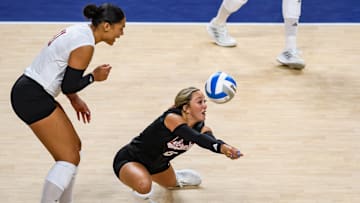 Laney Choboy passes a serve against Pitt in front of Teraya Sigler. Despite lower passing stats, NU's offense is hitting at a higher rate. 